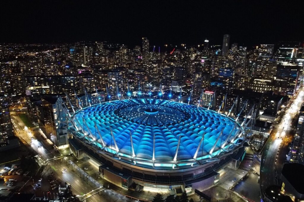 Illuminated BC Place Stadium in Vancouver at night, showcasing stunning cityscape views.
