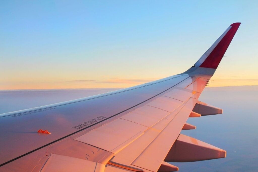 airplane wing view sunset flight long haul 2026