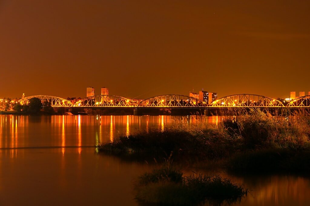 Warsaw Vistula riverside promenade urban beach sunset summer 2026